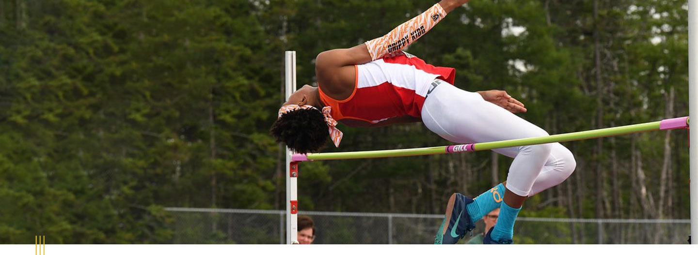 Image: Athlete clearing the bar in high jump event.