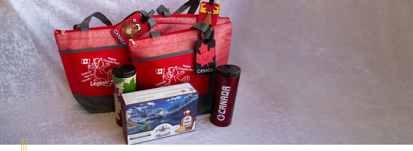 Legion branded care packages alongside some of the items inside including a box of maple cookies and two travel mugs.